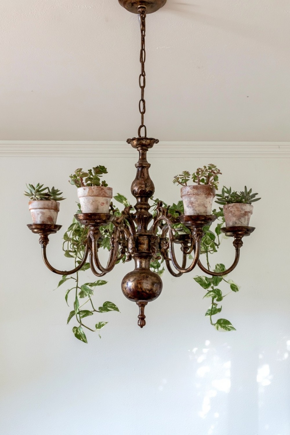 1. Turn An Old Chandelier Into A Hanging Planter
