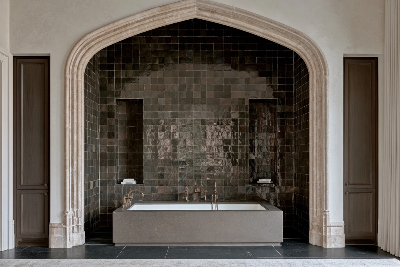 Gothic bathtub set within a dramatic arched alcove