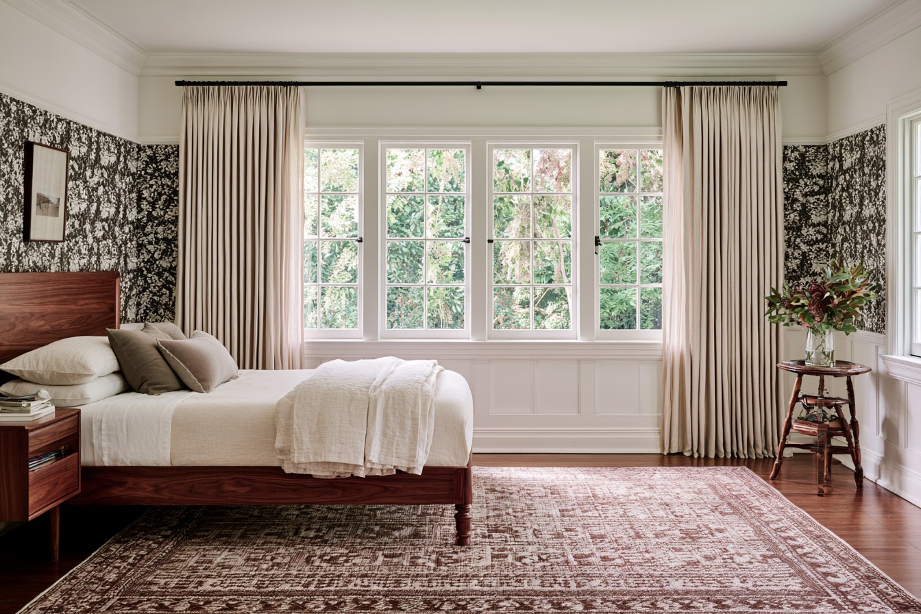 Bedroom curtains and shades arranged to reduce unwanted morning light