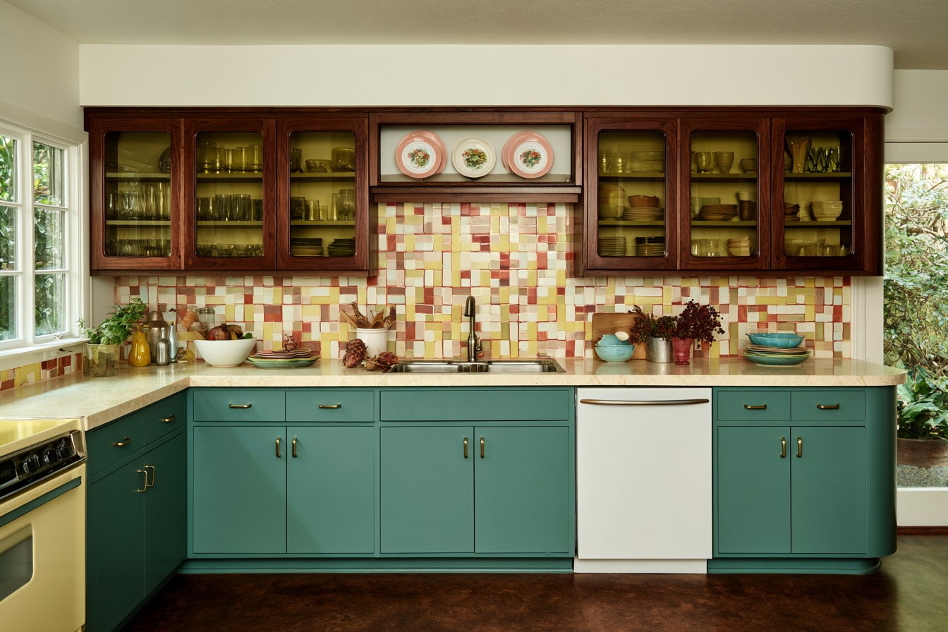 Retro kitchen cabinetry featuring smoked glass panels