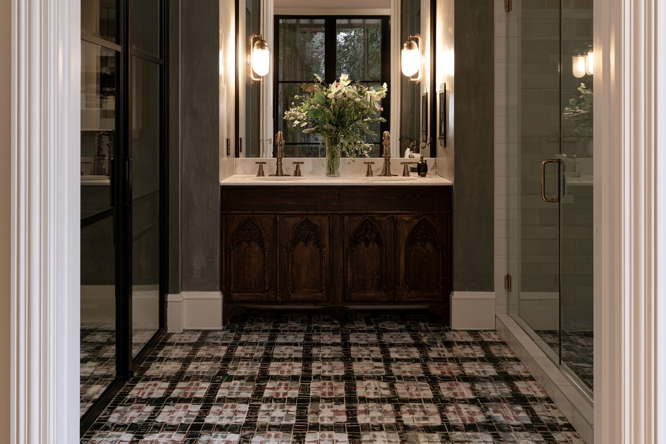 Medieval-inspired patterned floor in a dark bathroom interior