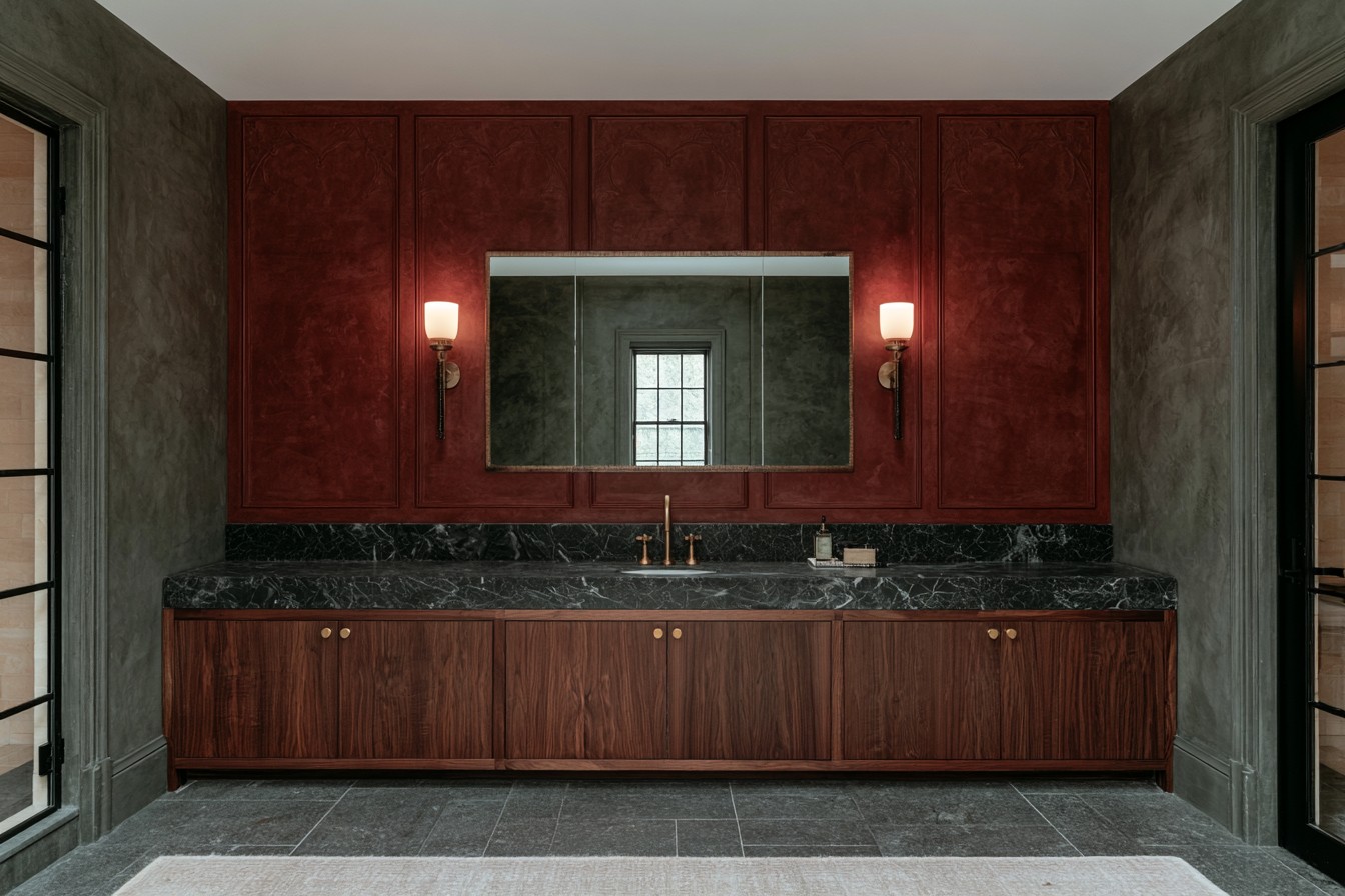Oxblood red feature wall behind a Gothic bathroom vanity
