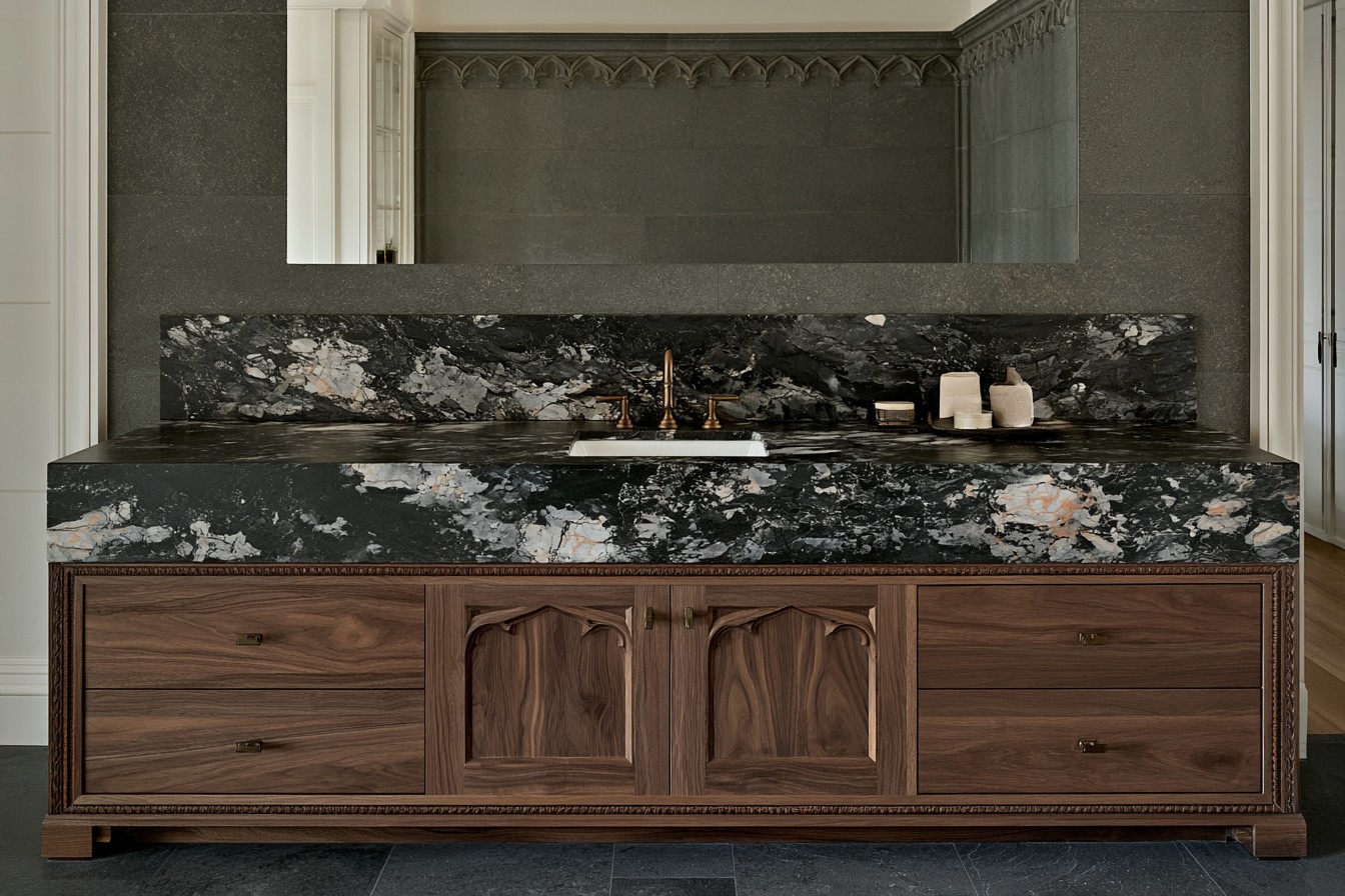 Black stone bathroom vanity with dramatic natural veining