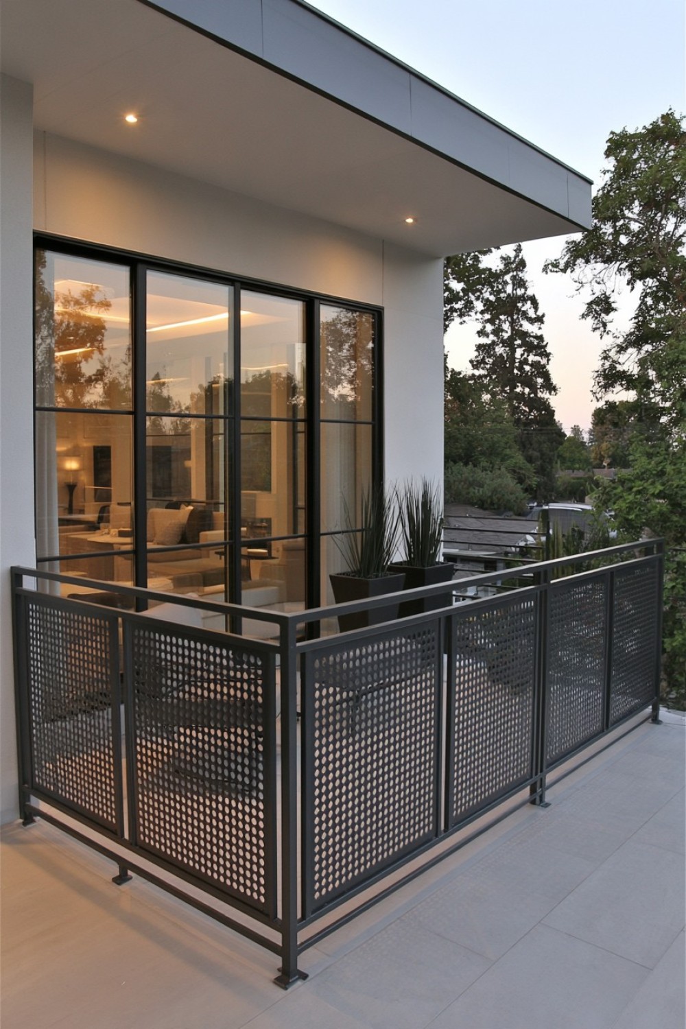 Perforated metal balcony railing providing filtered privacy