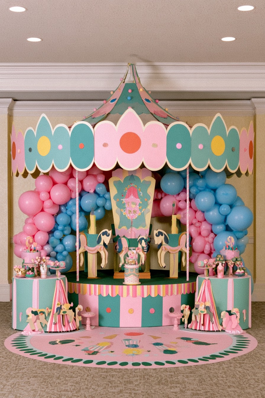 Pastel carousel gender reveal display with decorative horses balloons and desserts