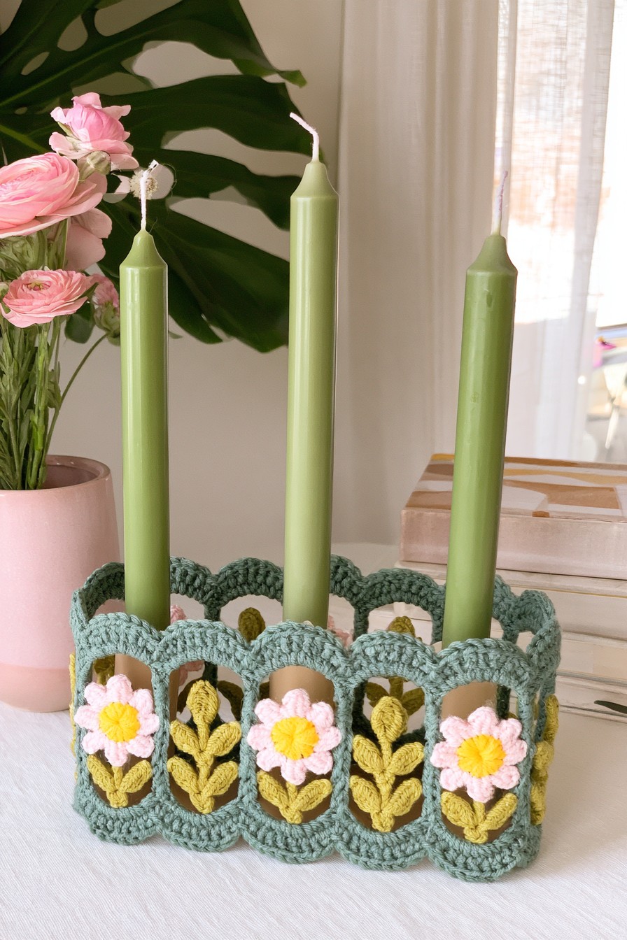 Green crochet floral tabletop decoration with pink blossoms