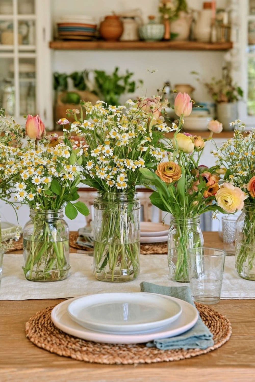 Spring table setting with fresh greenery and a soft natural palette