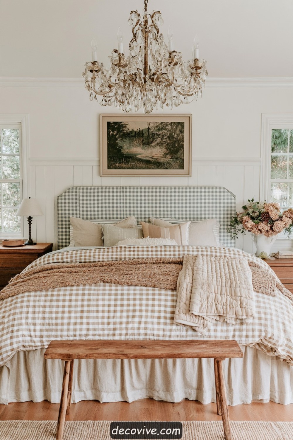 Farmhouse bed layered with linen, small checks, and woven textiles