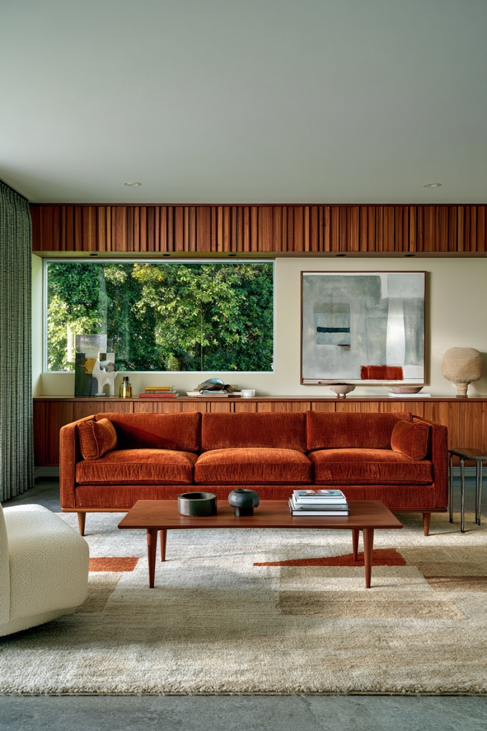 Burnt orange statement sofa in a mid-century modern living room