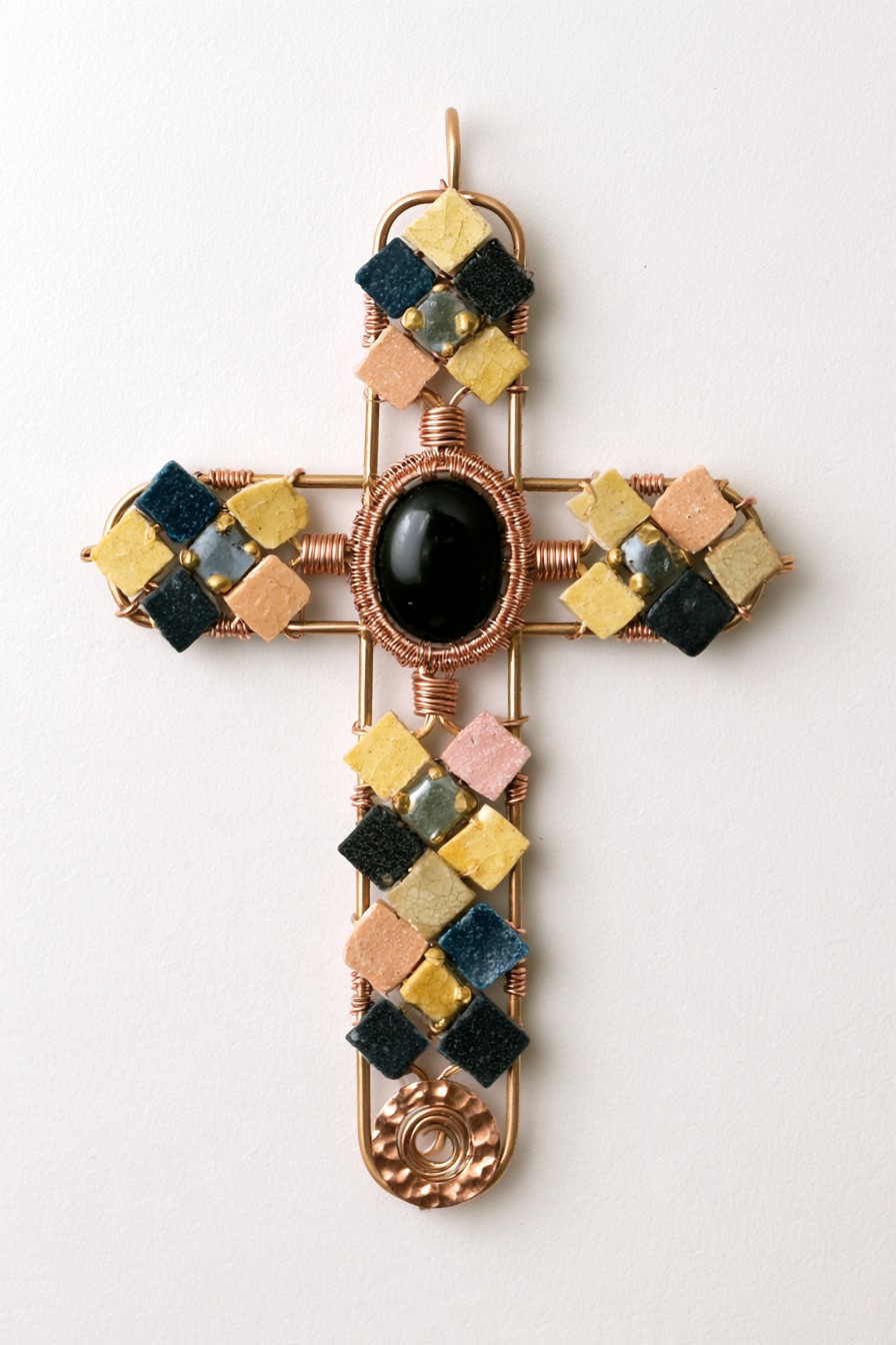 Mosaic-inspired copper cross with color-block tile accents