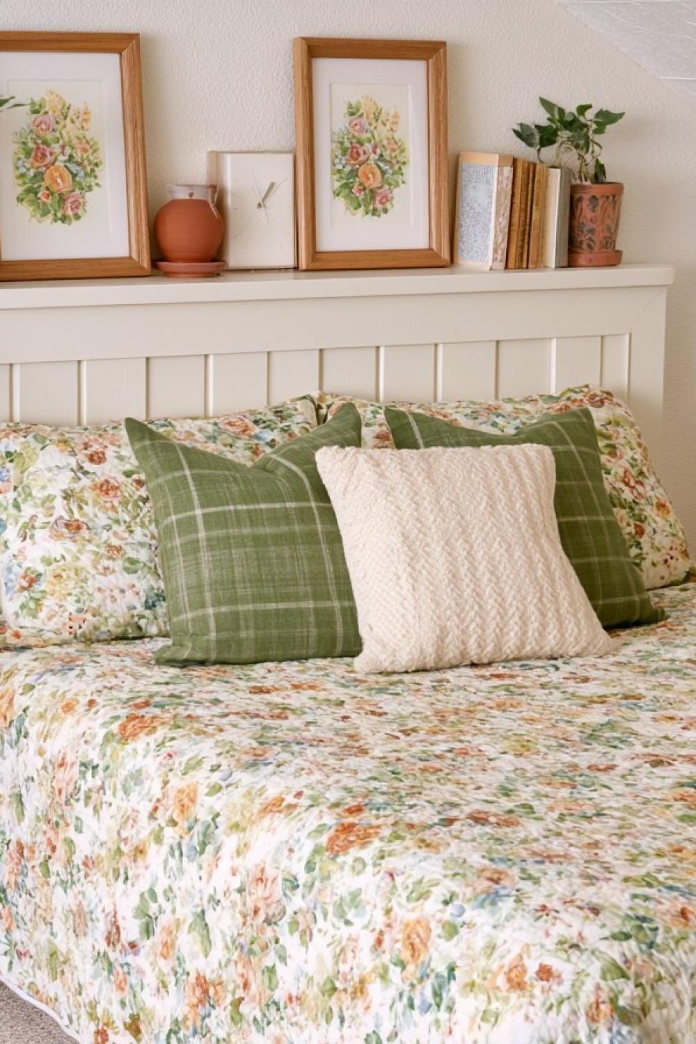 Cottage-style attic bedroom with floral textiles and painted furniture