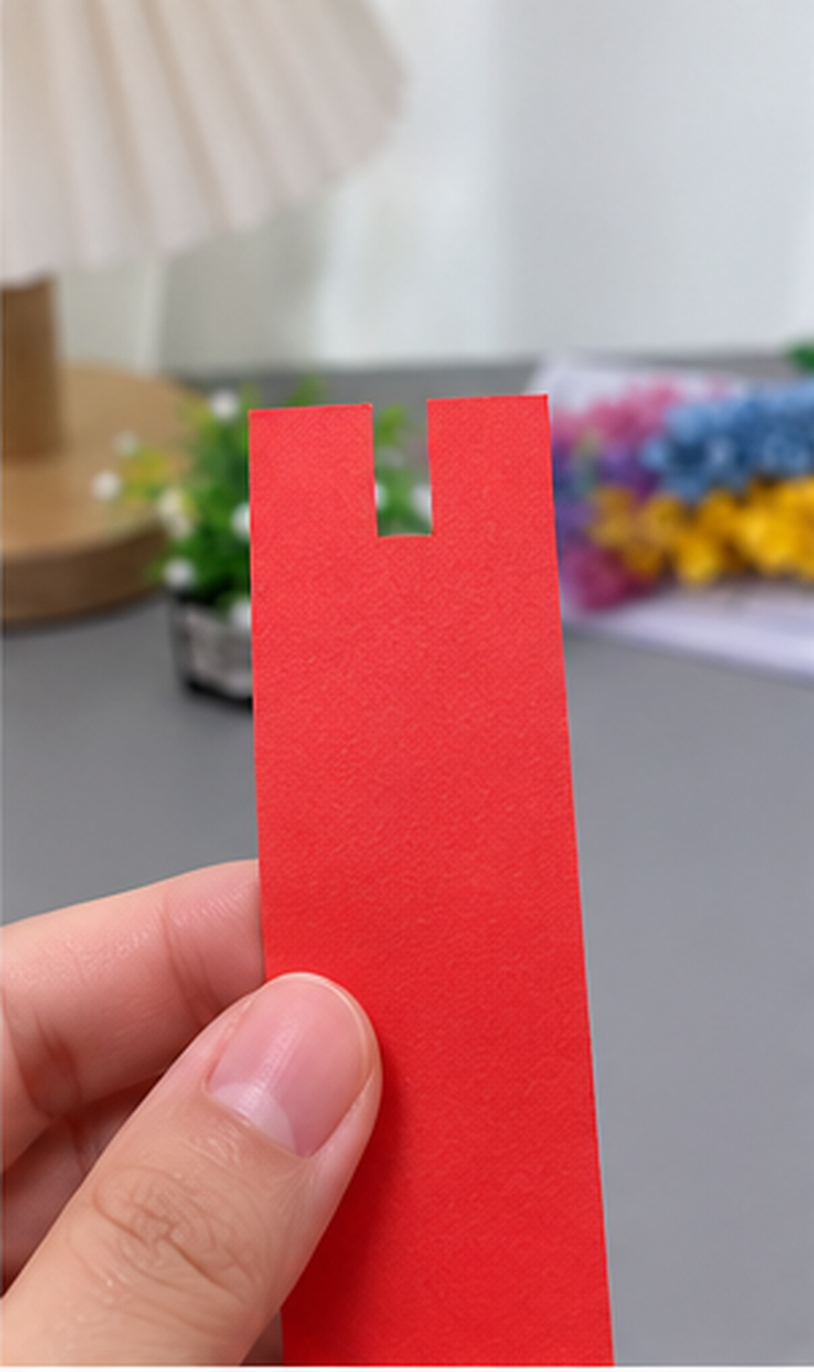 Rectangular notch cut into the top center of the red paper strip for two eye stalks