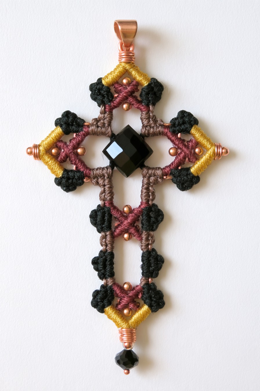 Knotted cord cross with geometric black crystal center
