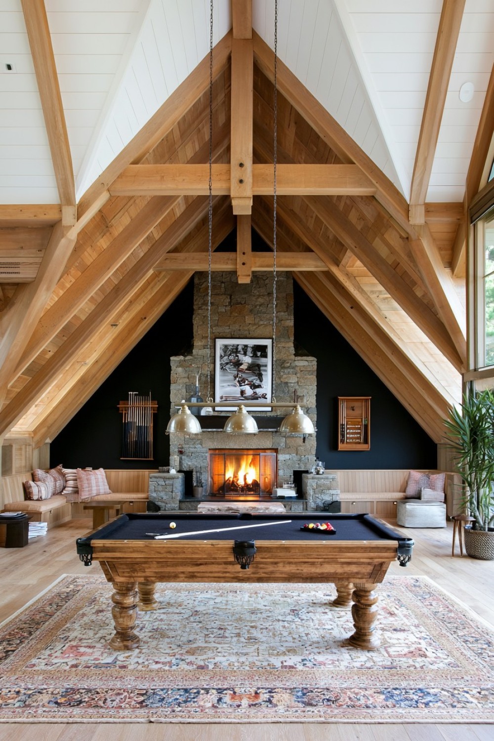 Compact billiards area positioned beneath the center of an attic