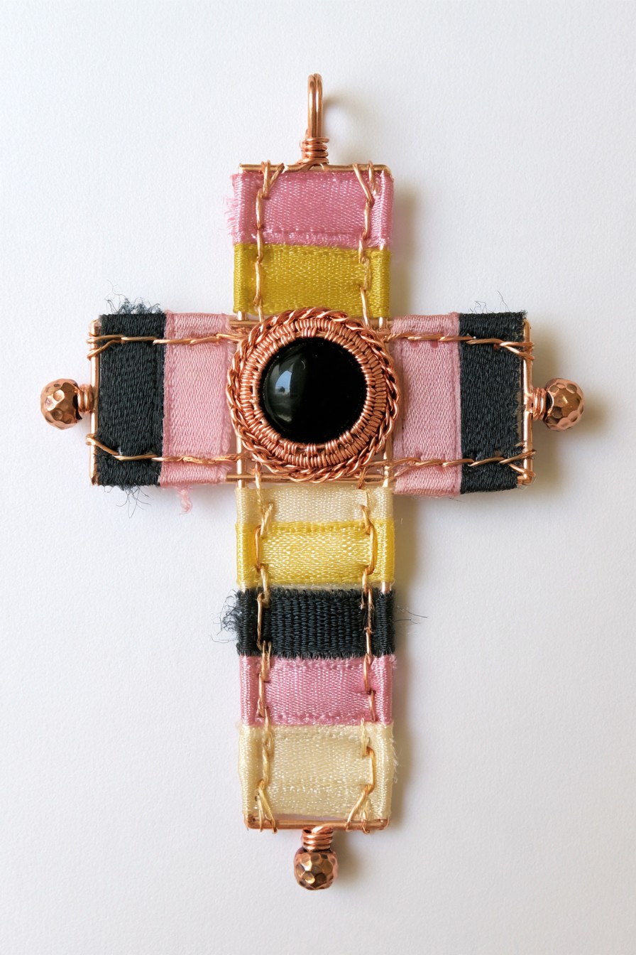 Ribbon-wrapped cross with copper weaving and black center stone