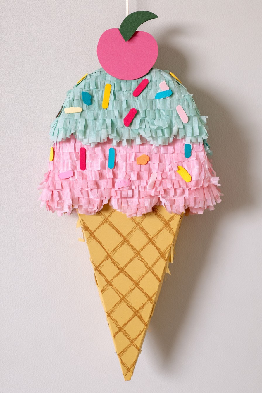 Pastel ice cream cone piñata with sprinkles and cherry detail