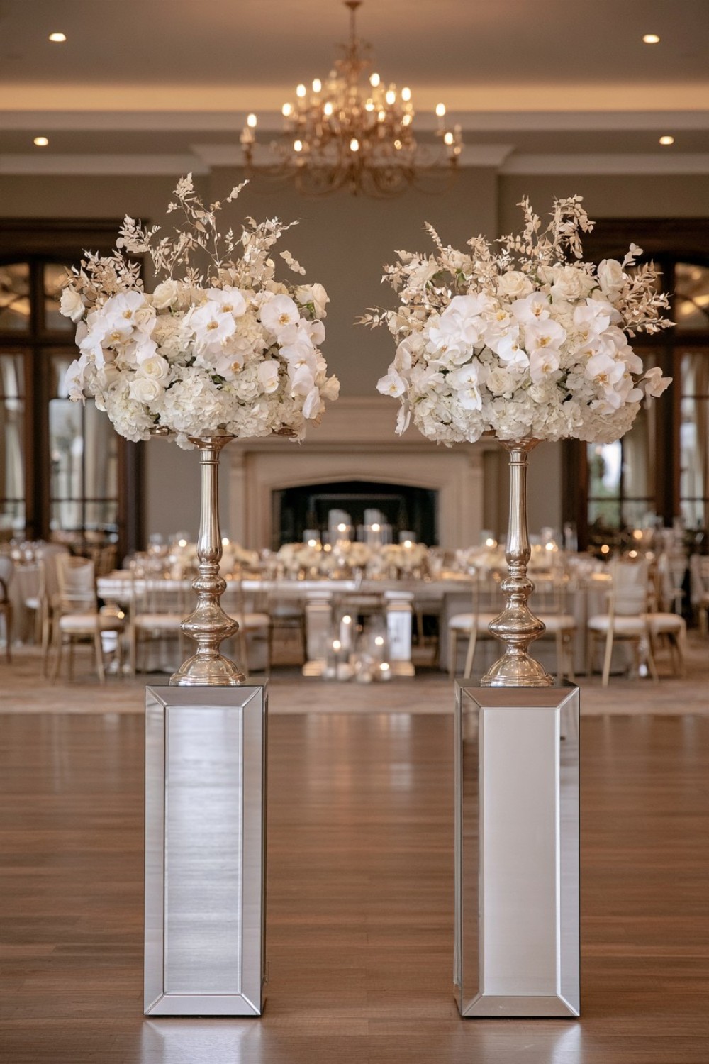 14. Reflective Columns With White Floral Arrangements