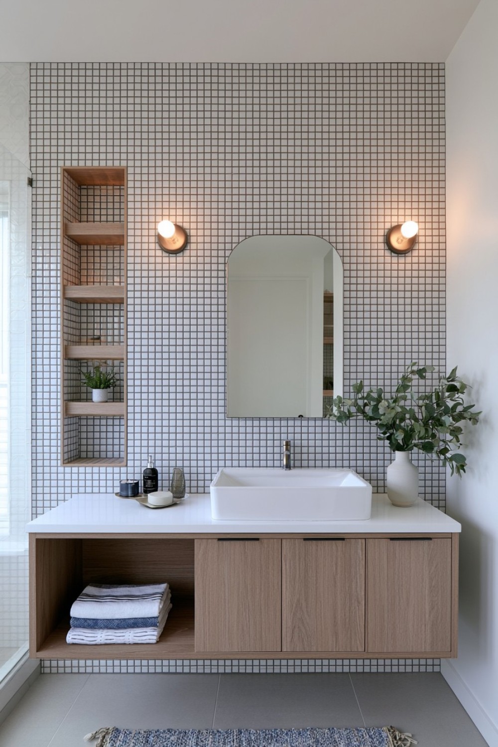 Small bathroom with recessed storage between wall studs