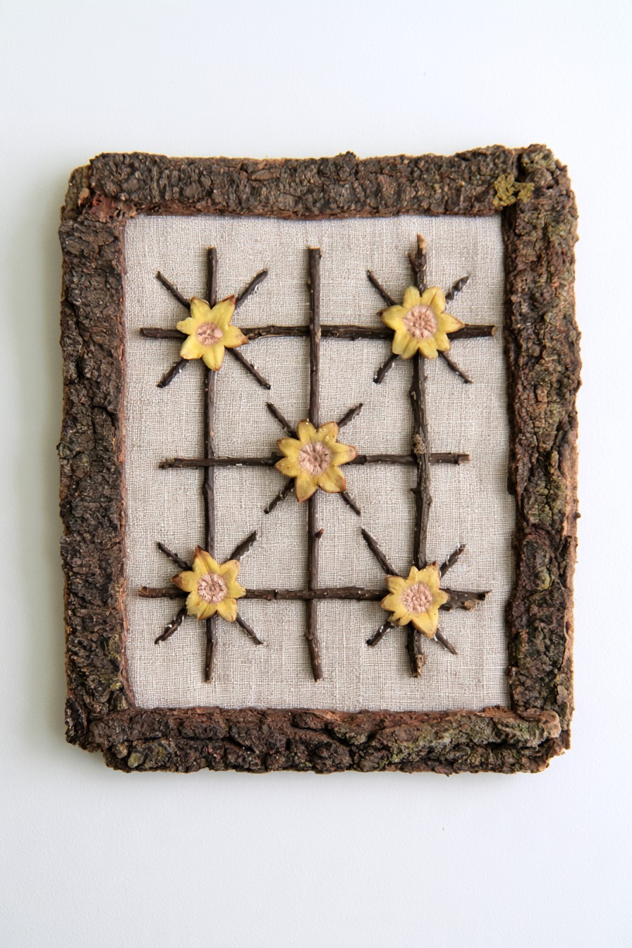 Twig grid wall art set on fabric and surrounded by an irregular bark frame