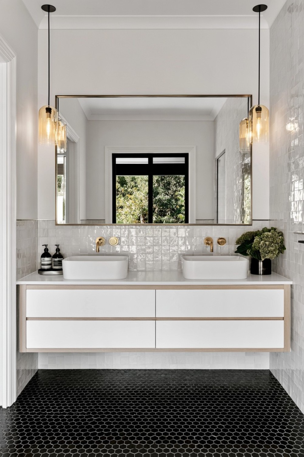 Black hexagon bathroom floor paired with soft white walls