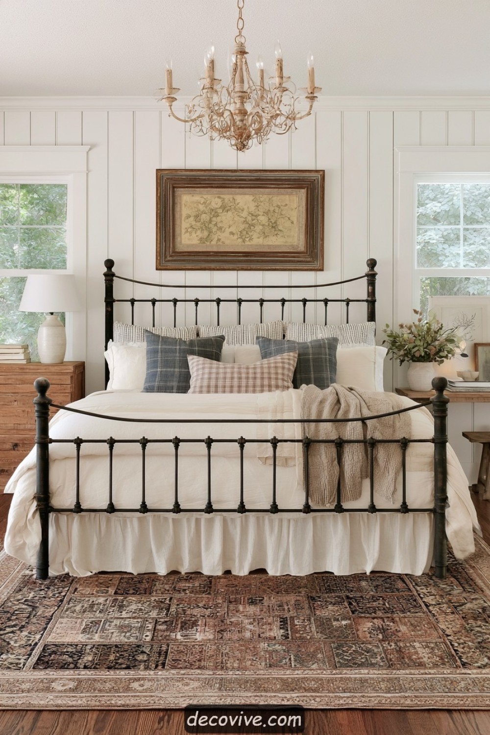 Antique iron farmhouse bed paired with ticking-stripe bedding