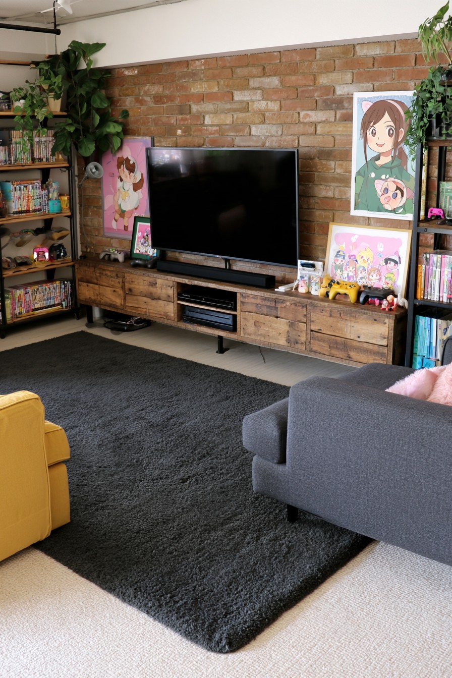 Brick television wall with a long timber cabinet, open game shelves, gray seating, and a dark rug