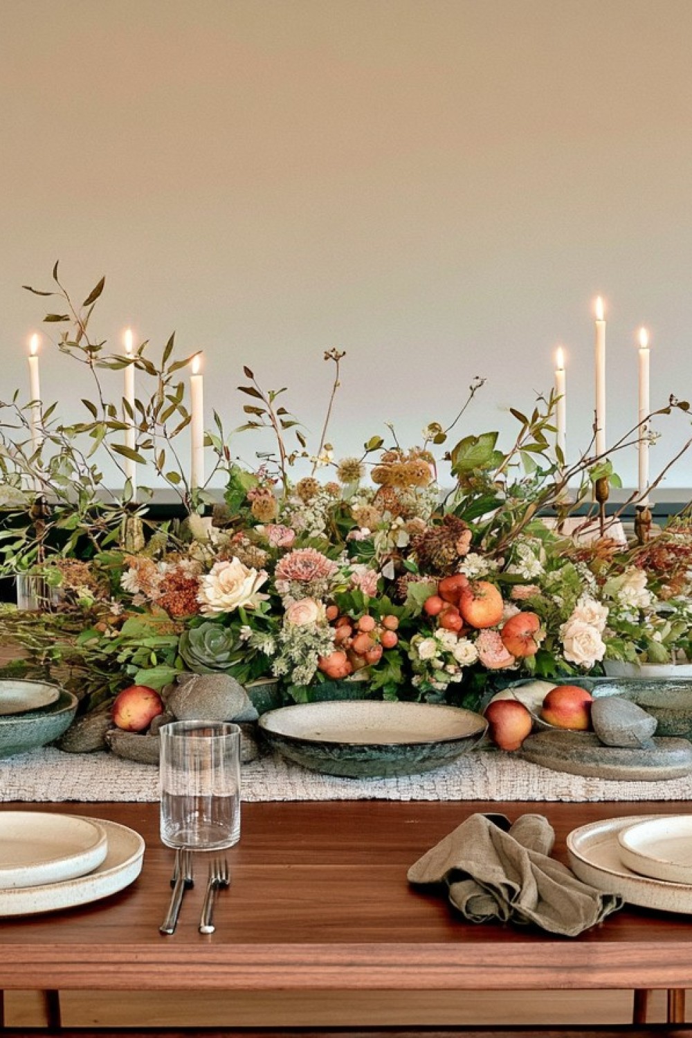 Low linear centerpiece leaving space for dining and conversation