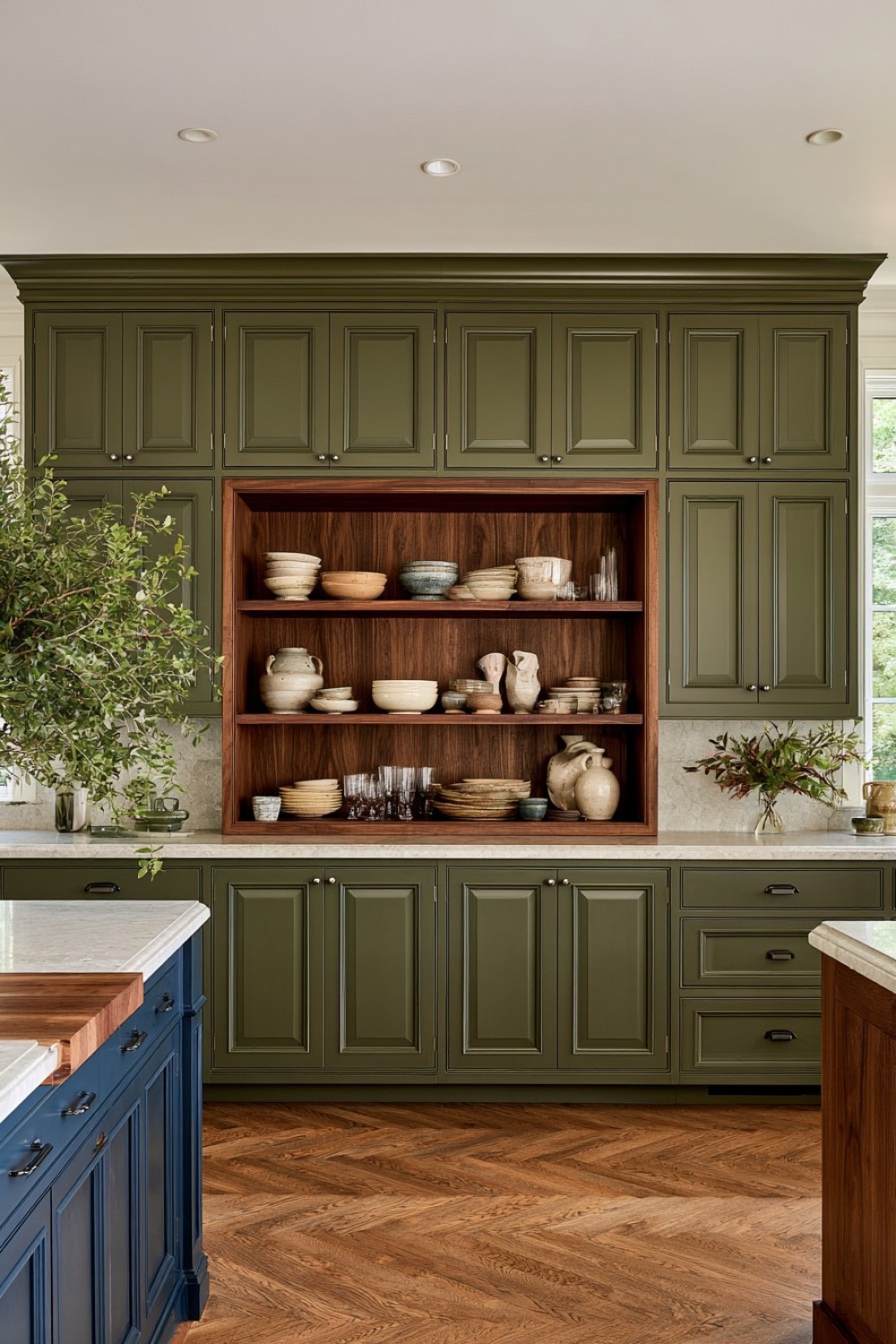 Open kitchen display cabinet positioned between closed storage
