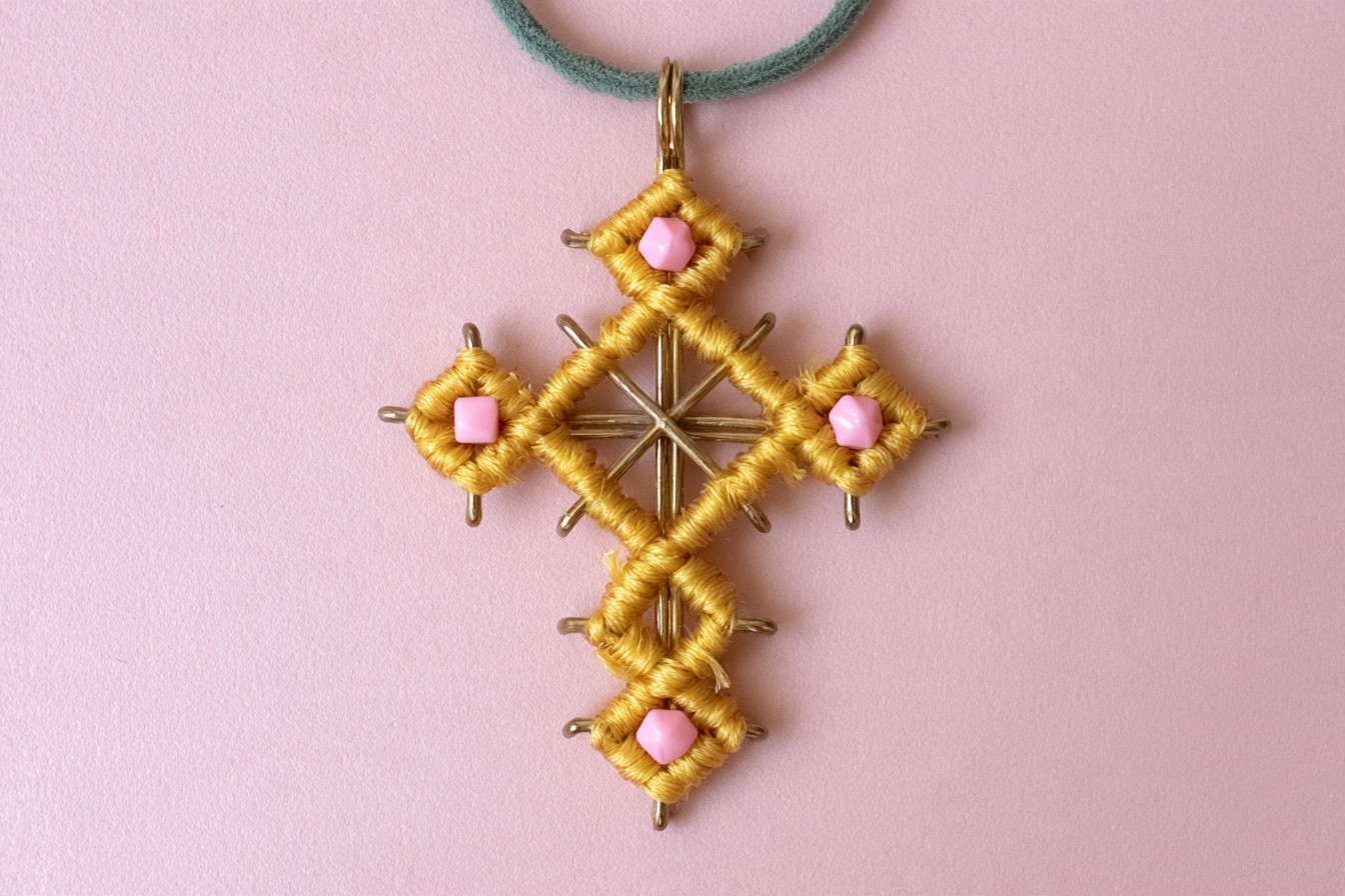 Geometric thread-wrapped cross with pink bead accents