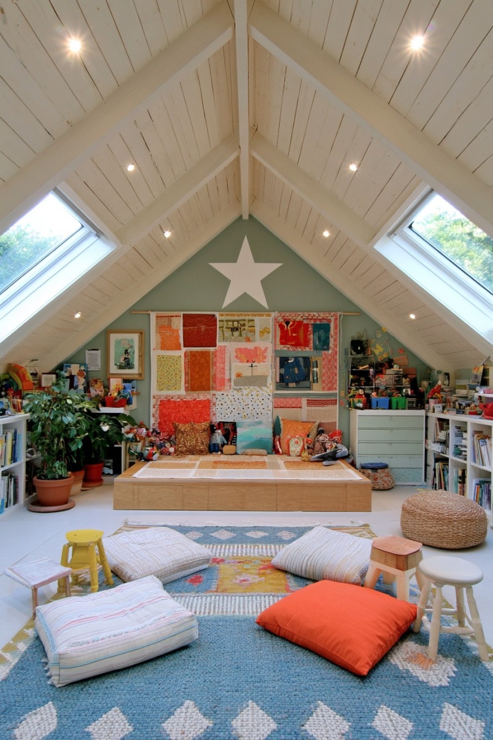 Low flexible pretend-play stage inside an attic playroom