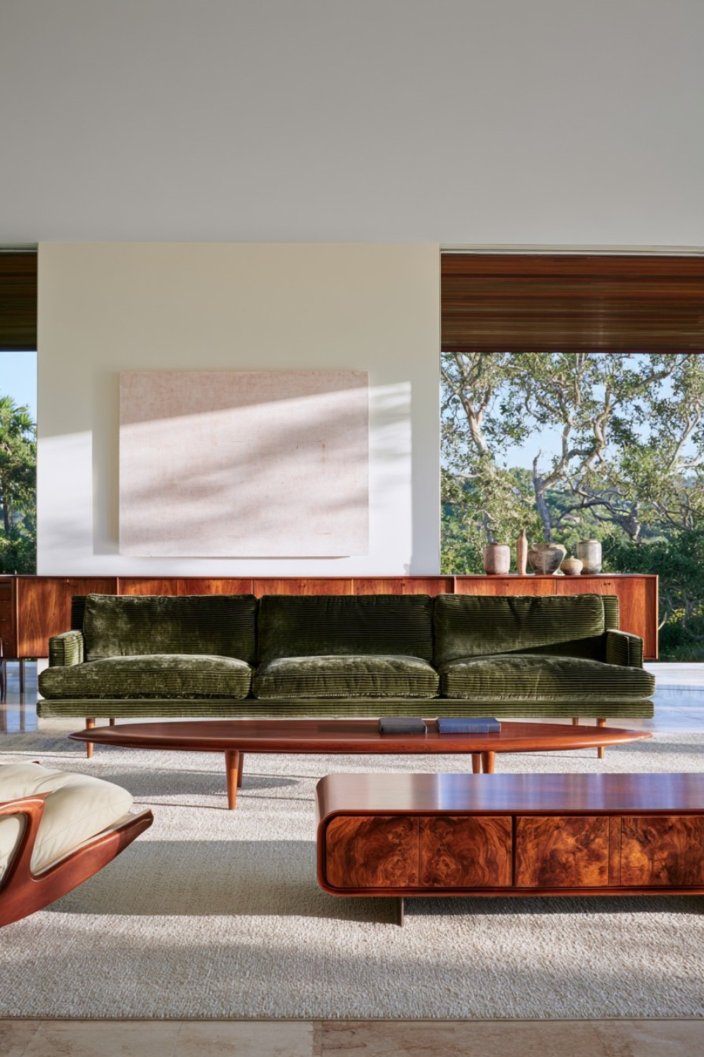 Olive green upholstery paired with teak furniture in a living room