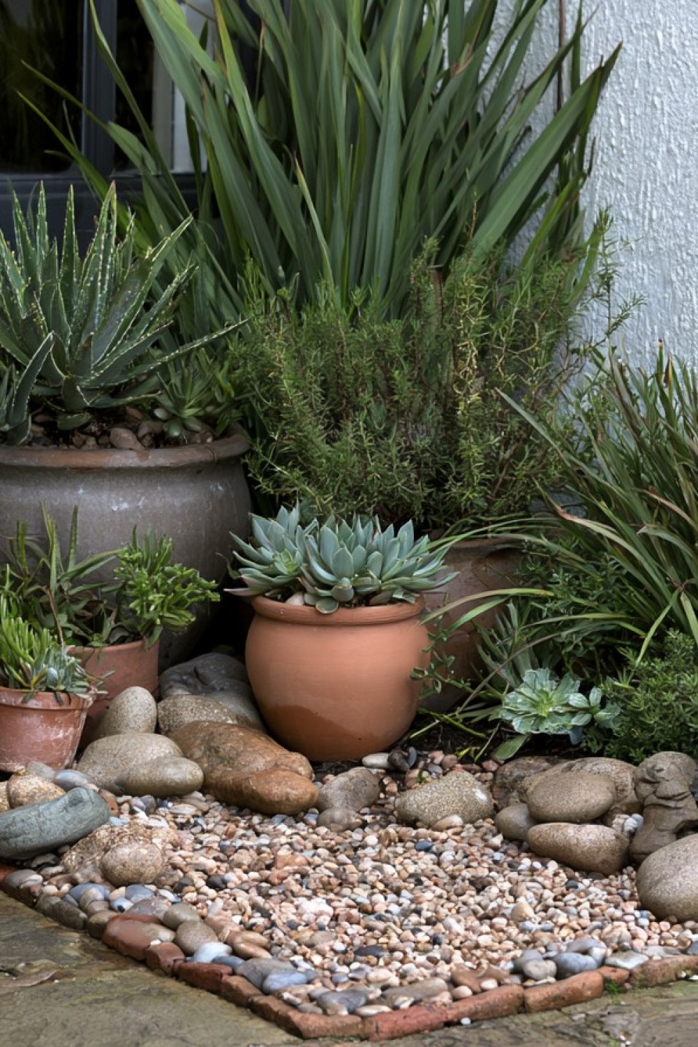 Compact pebble garden created in an unused patio corner