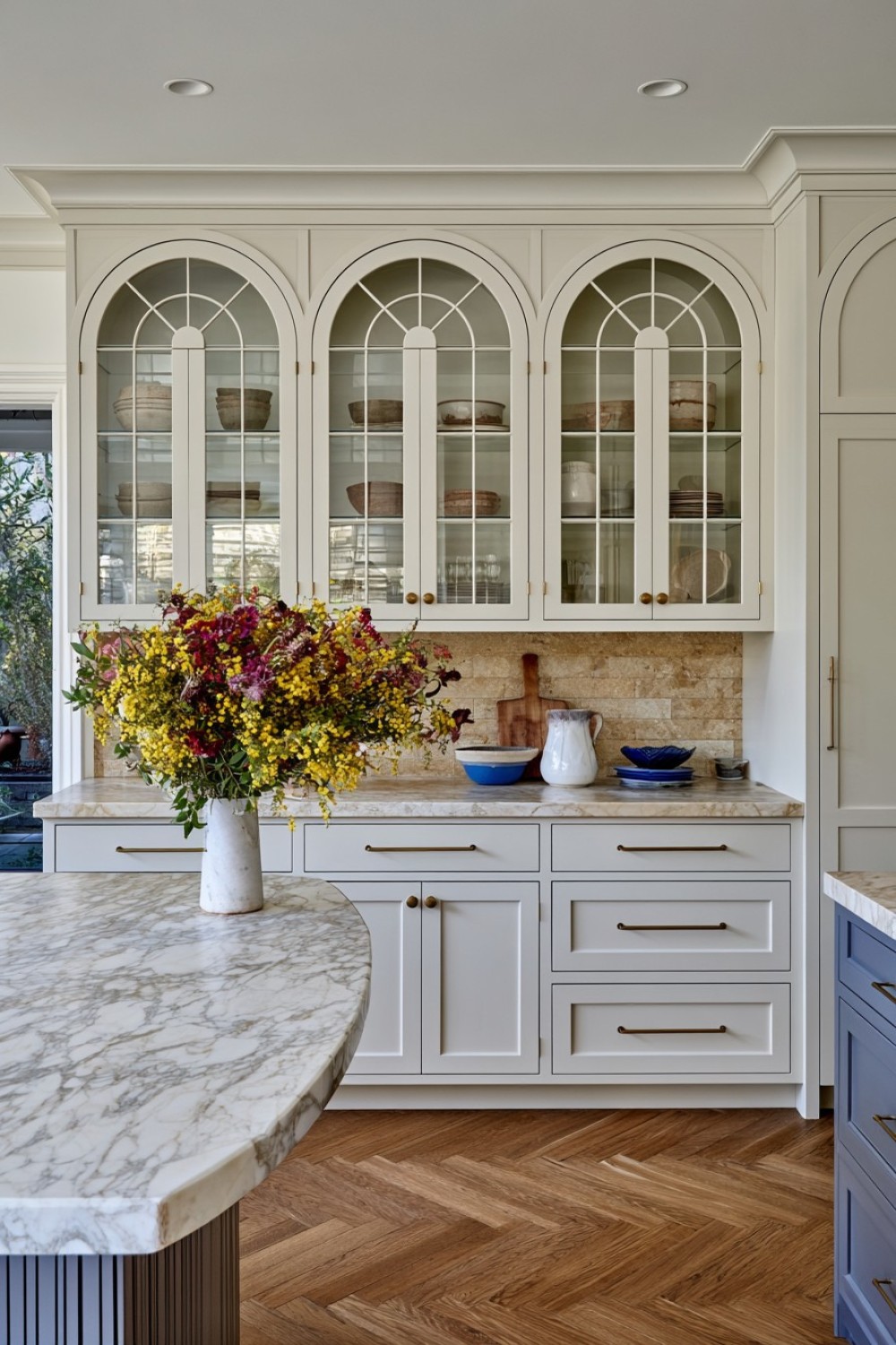 Arched upper cabinet doors adding softness to a kitchen