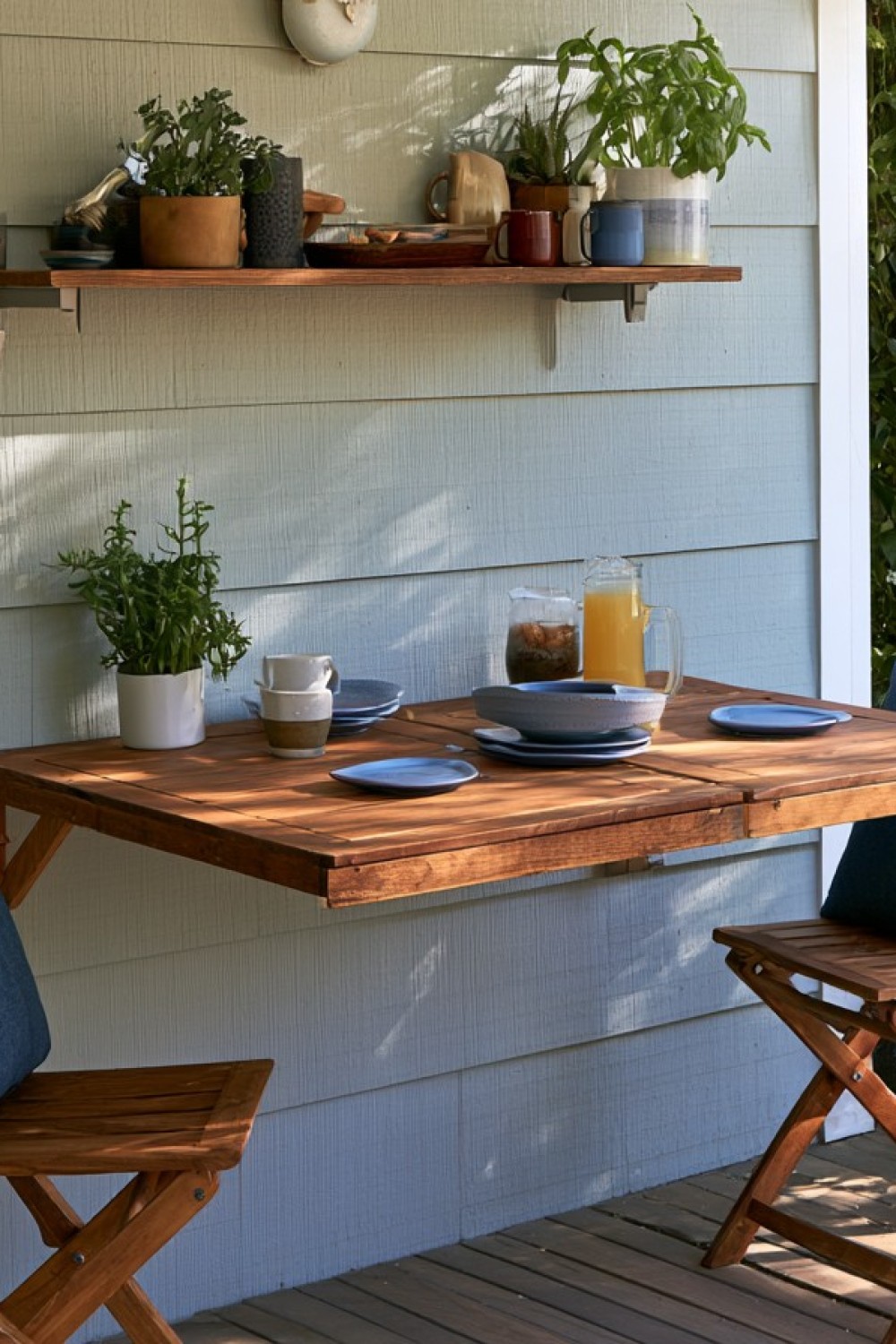 Space-saving folding wall table on a small patio