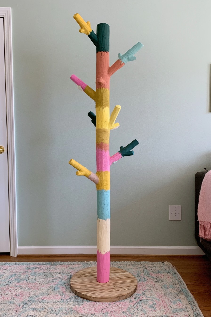 Tree shaped wooden coat rack painted in pink mustard coral blue cream and green
