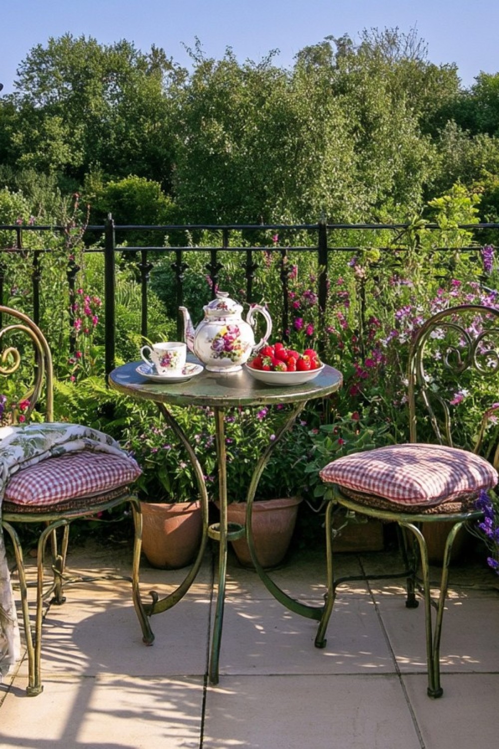 Compact folding bistro table and chairs on an English cottage balcony