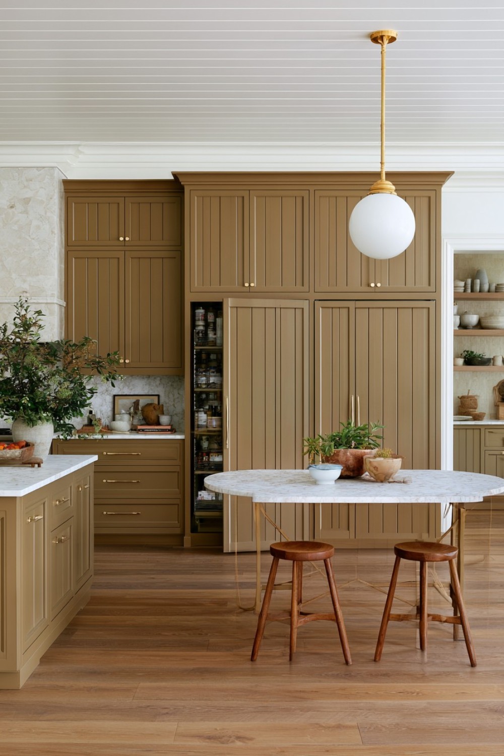 Hidden kitchen pantry entrance disguised as cabinetry