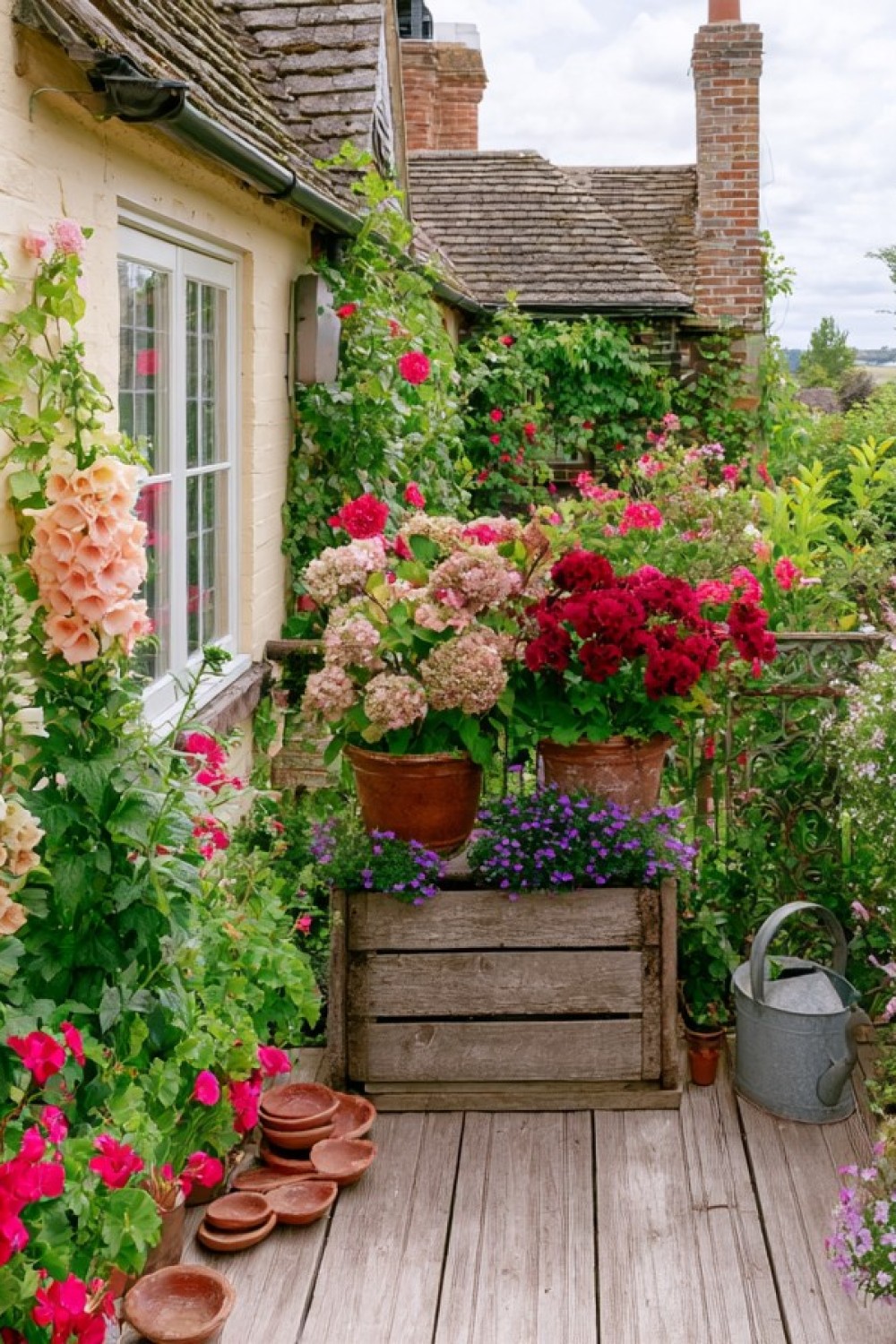 Layered cottage flowers arranged by height on a compact balcony