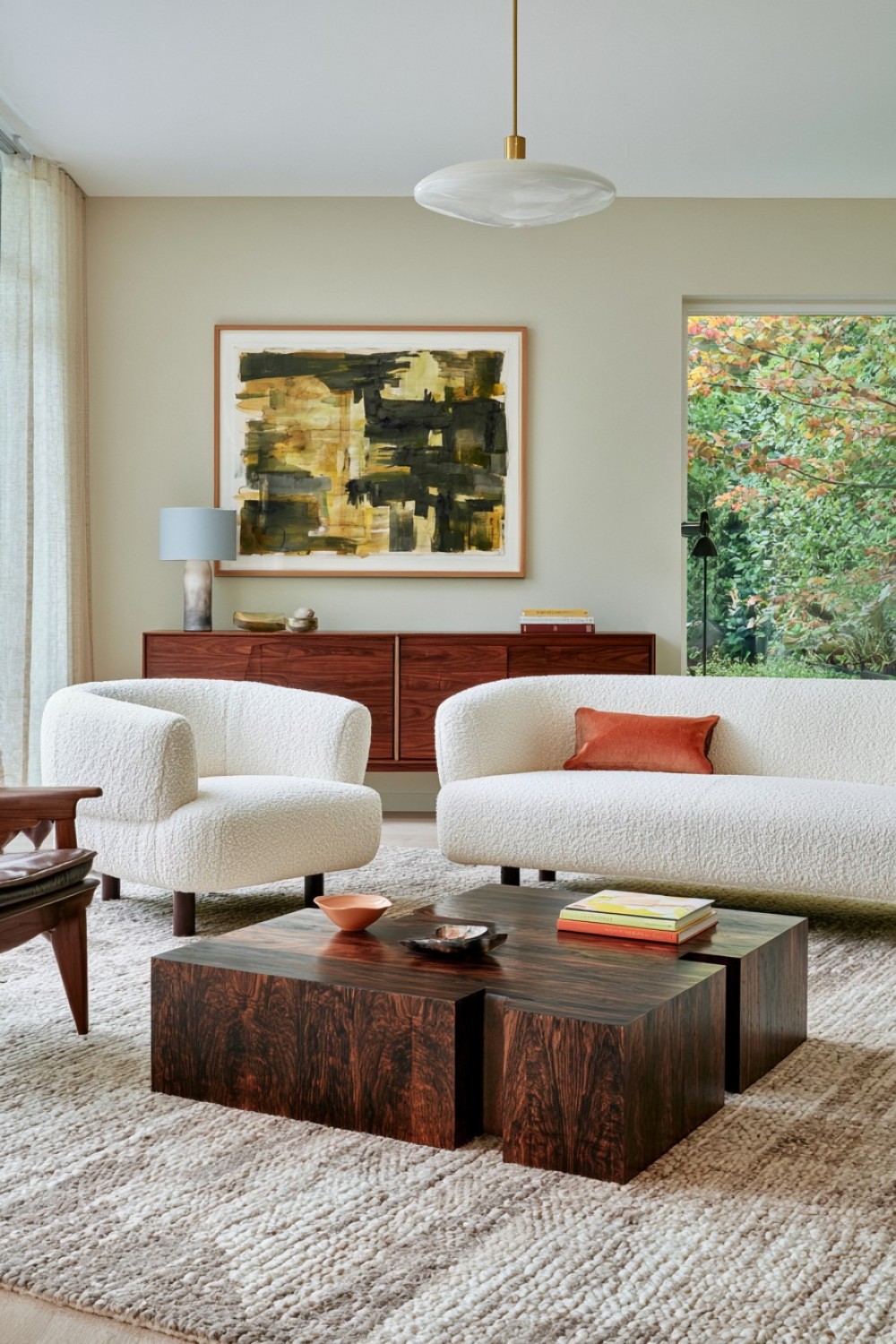 Cream boucle seating contrasted with dark walnut furniture