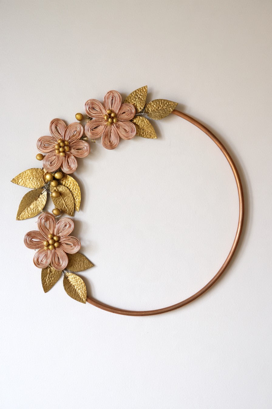 Copper hoop wall decoration with wire flowers and hammered metal leaves