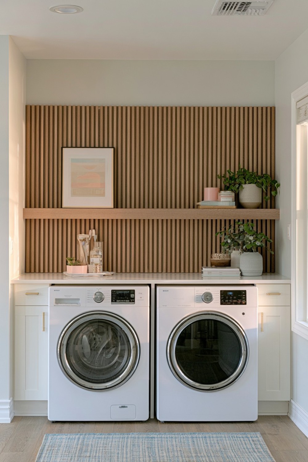 Moisture-resistant slatted feature wall in a basement laundry room