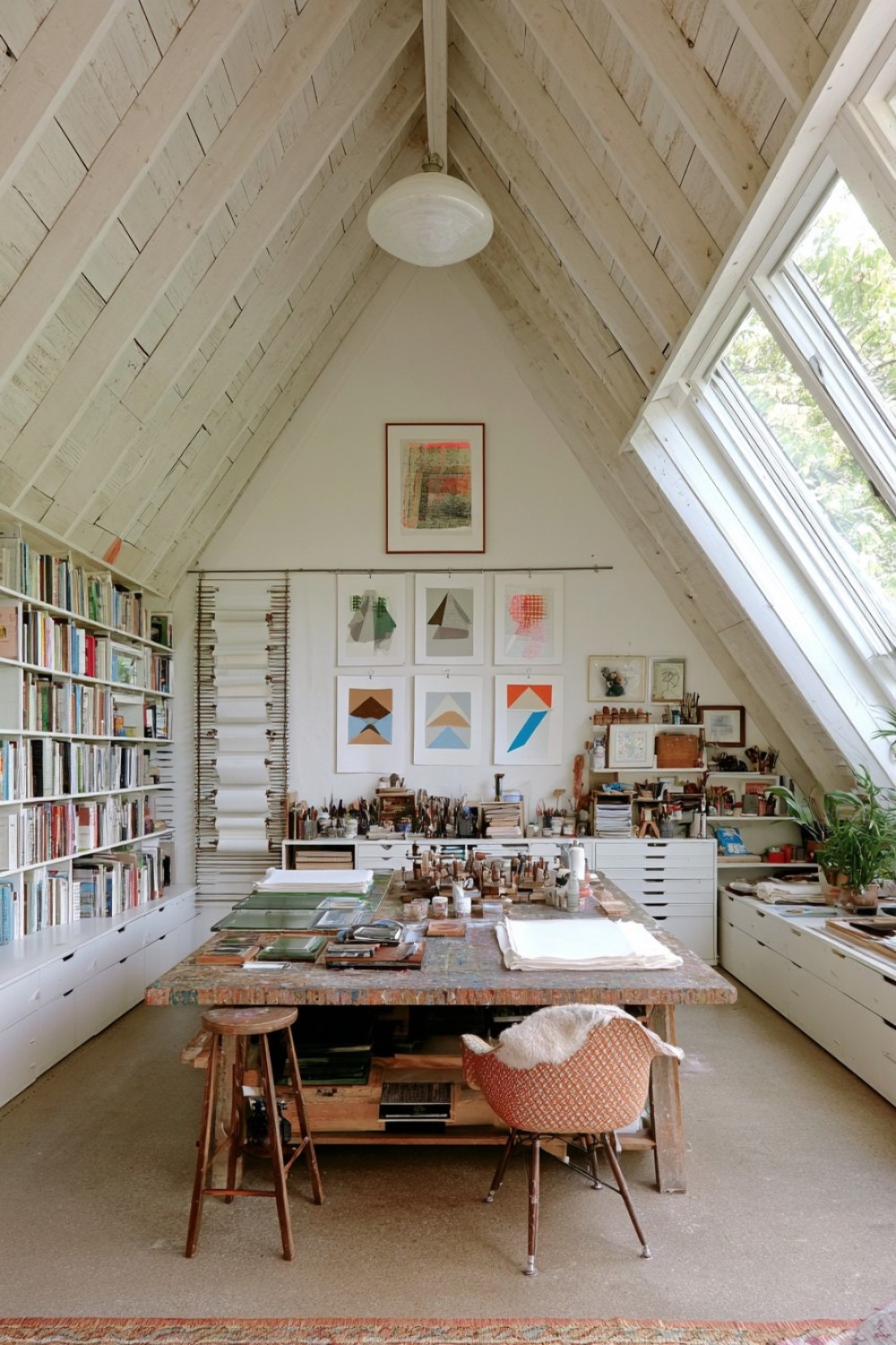 Attic printmaking studio with organized drying and paper storage