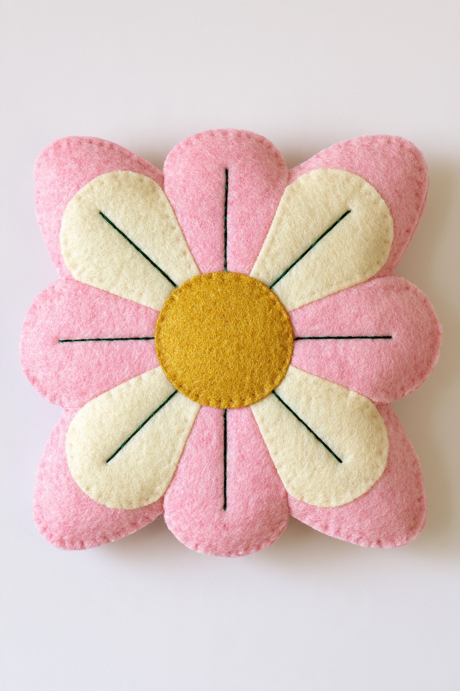 Pink padded flower pillow with cream appliqué petals