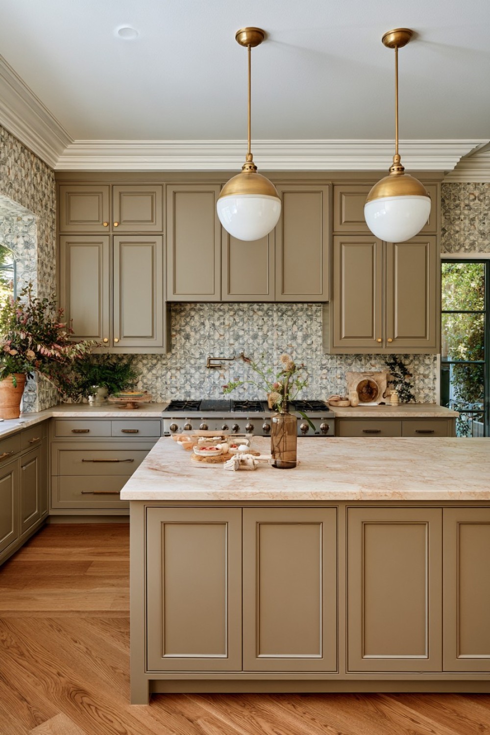 Warm mushroom kitchen cabinets with layered neutral surfaces