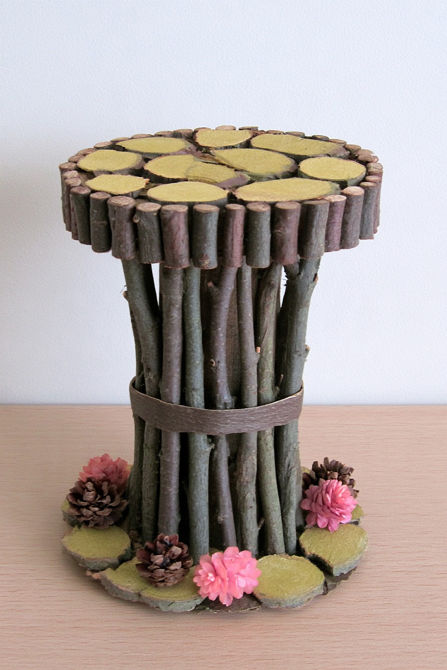 Decorative pedestal with a bundled twig column and wood slice mosaic top