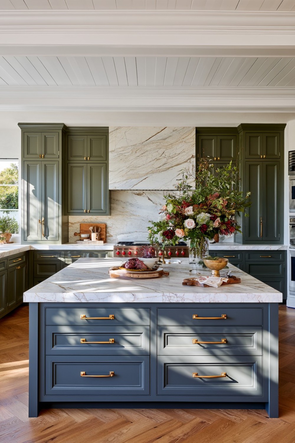 Deep olive kitchen cabinets paired with a pale stone countertop