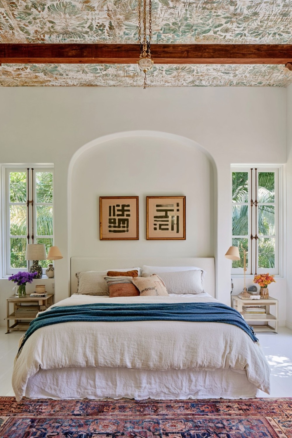 Eclectic bedroom with a carefully patterned ceiling