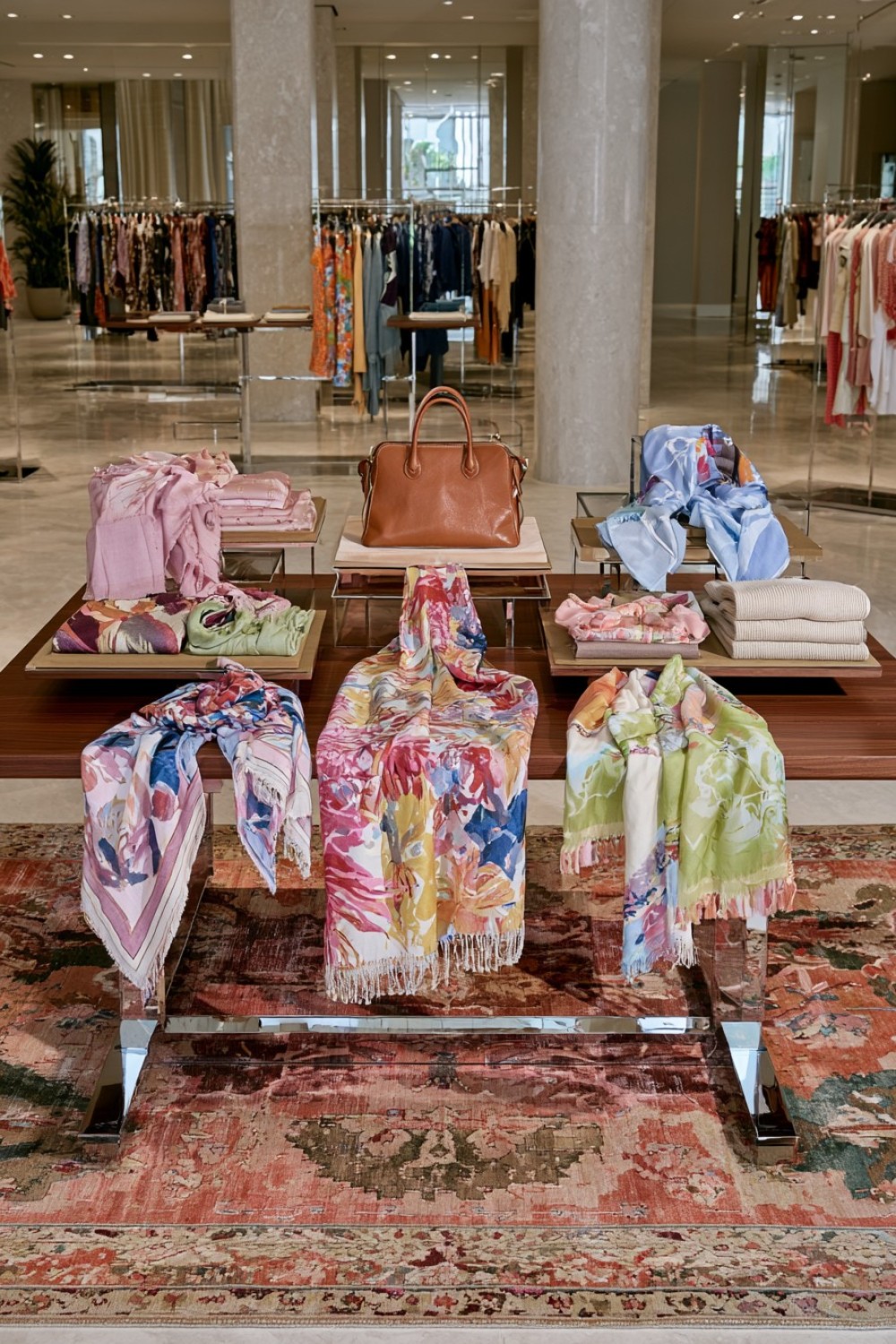 Seasonal boutique scarf story arranged on a display table