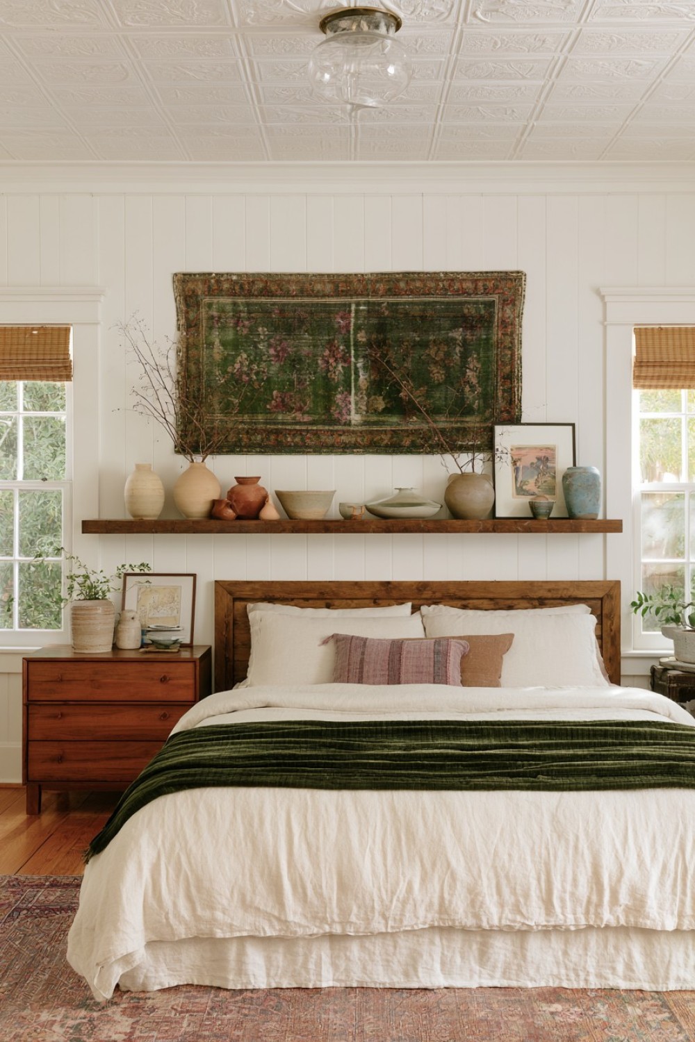 Curated handmade pottery collection in a bohemian bedroom