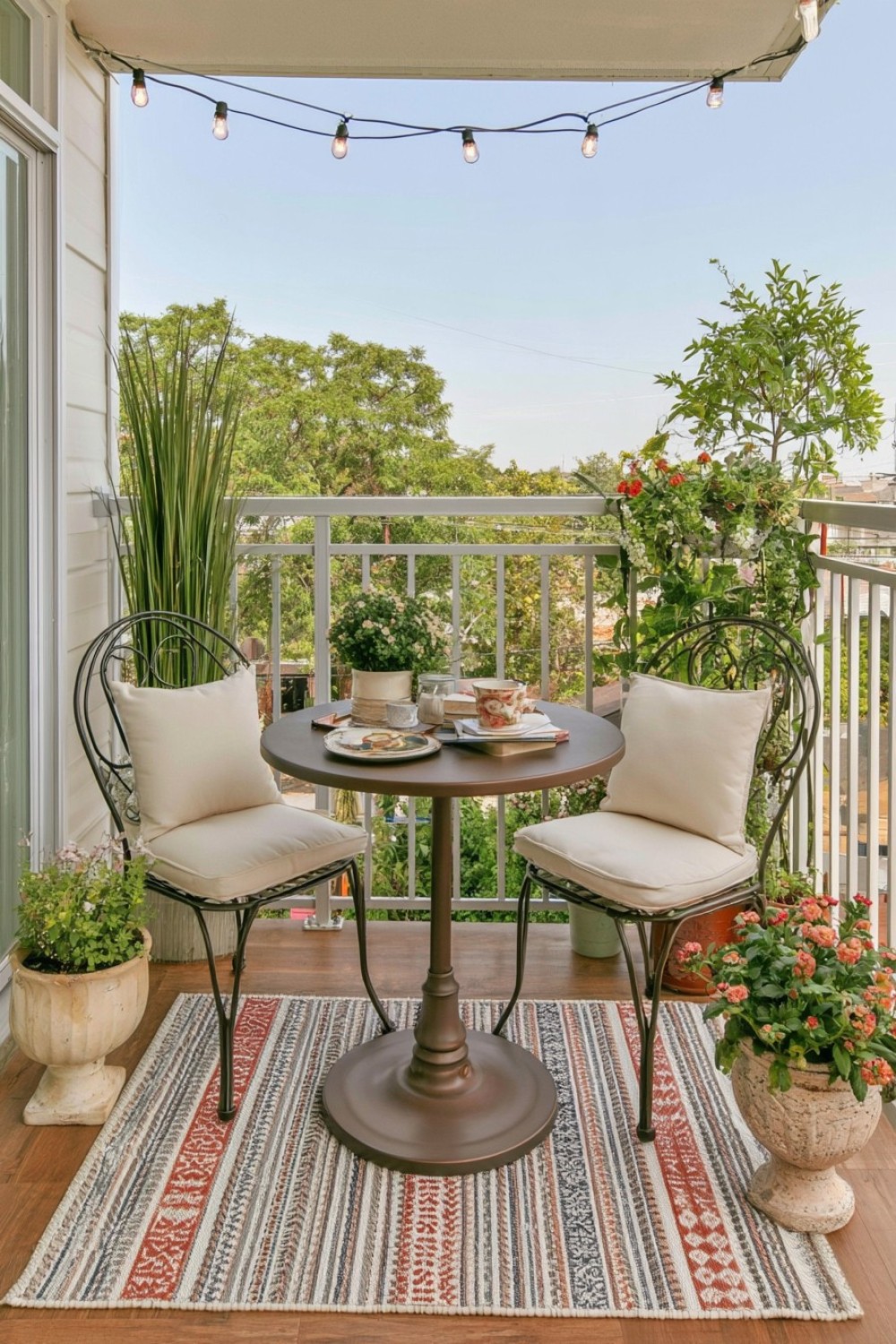 Parisian inspired balcony with slim furniture and elegant greenery